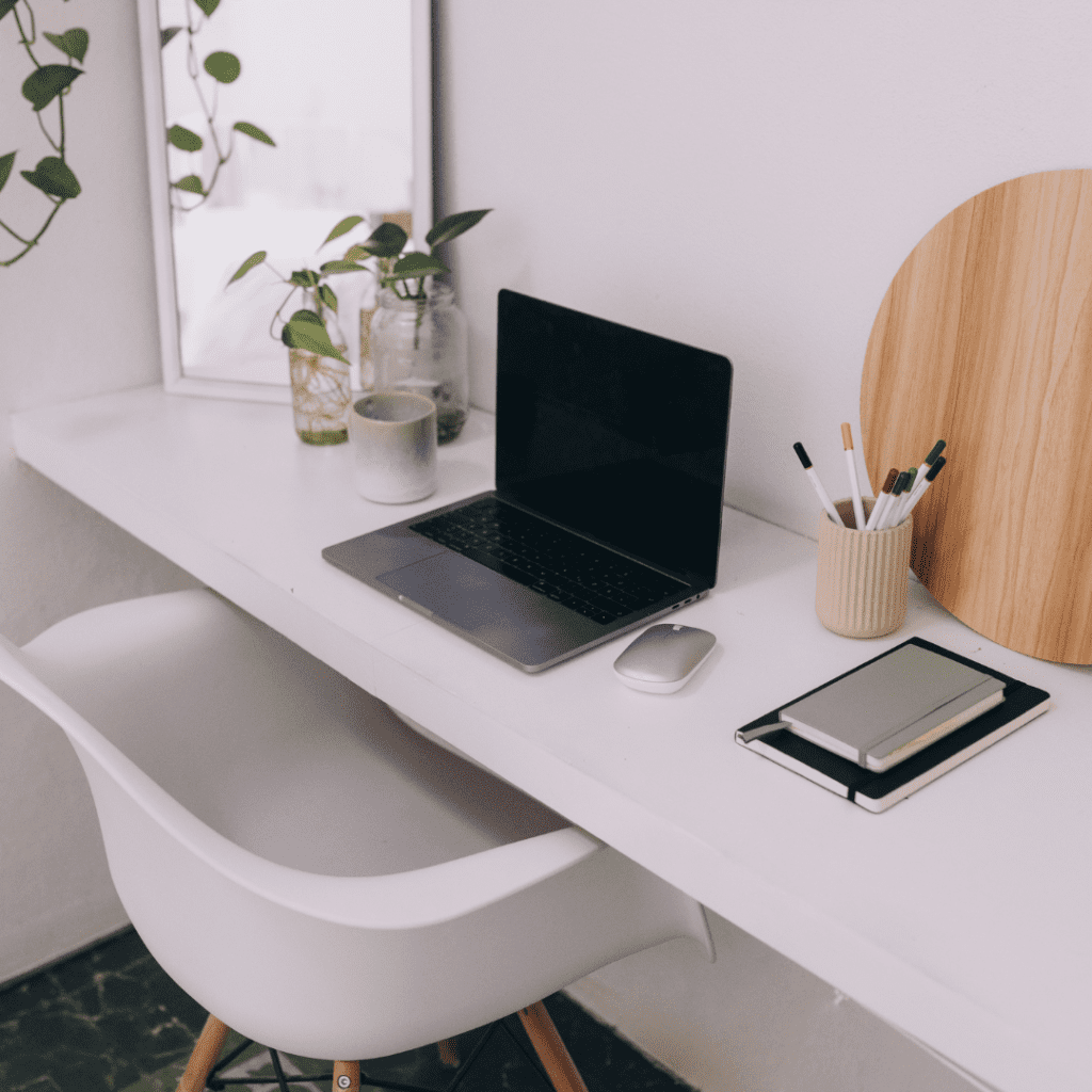 a laptop on a table with some plants and notebooks, image for website home page